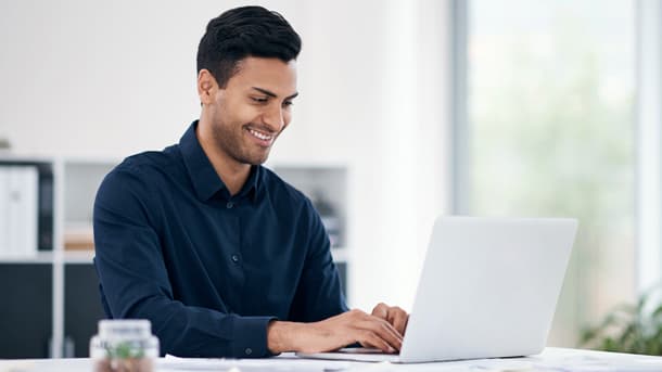 Man at table with laptop
